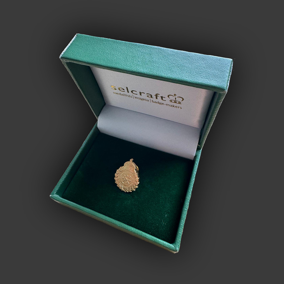 Image of branded jewellery produced for Welsh Ambulance Service displayed in its presentation case.  Jewellery and case produced by Selcraft UK Ltd