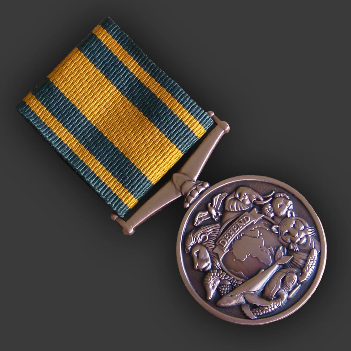 Bronze-finish conservation medal with relief wildlife design on a green and gold ribbon, made by Selcraft