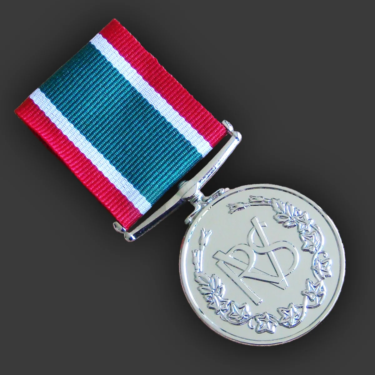 Silver-finish volunteer service medal with laurel wreath design on a green, white and red ribbon, made by Selcraft